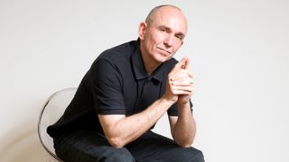 Peter Molyneux in a chair.